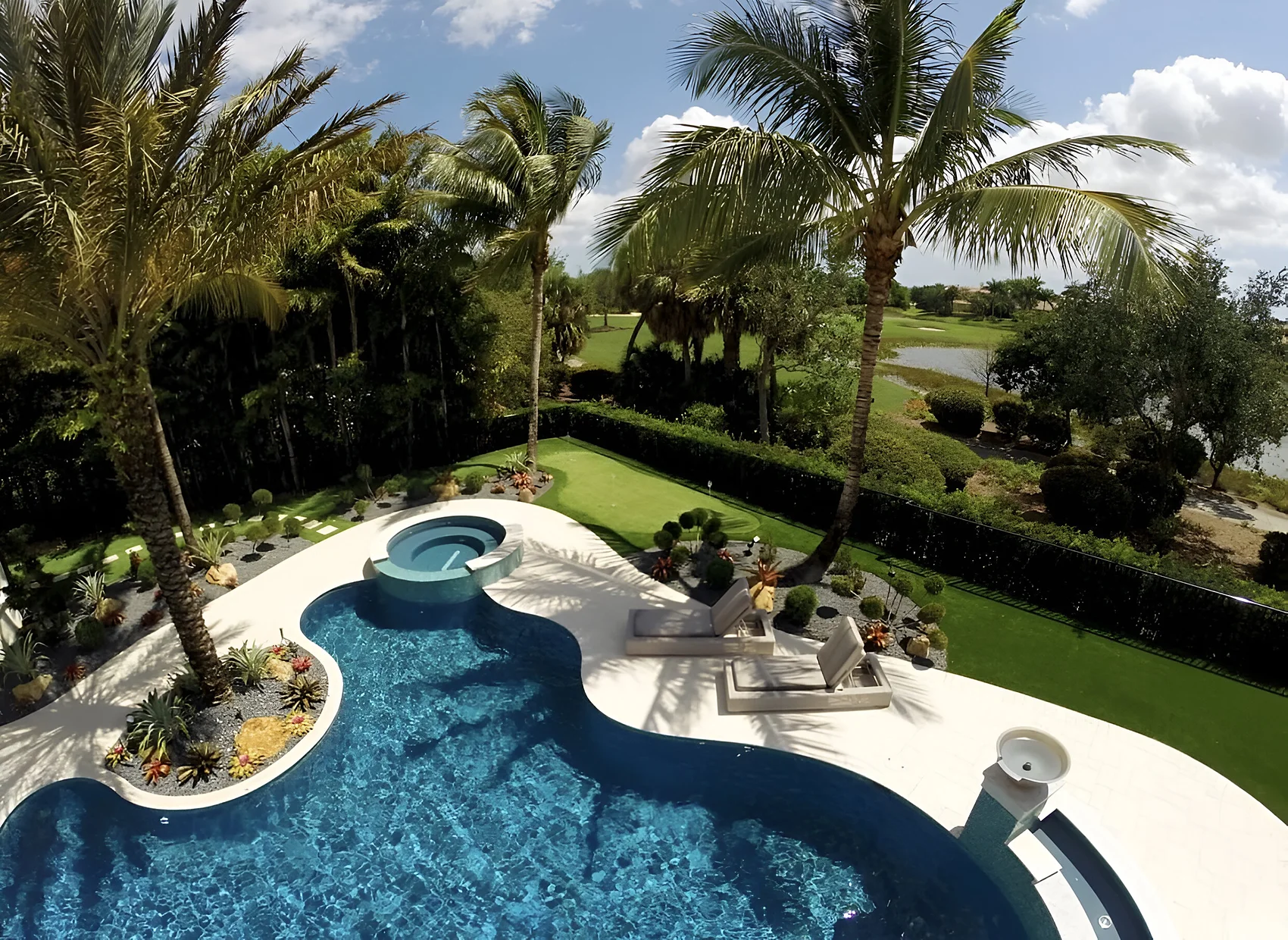 Private putting green beside a pool, seen from above