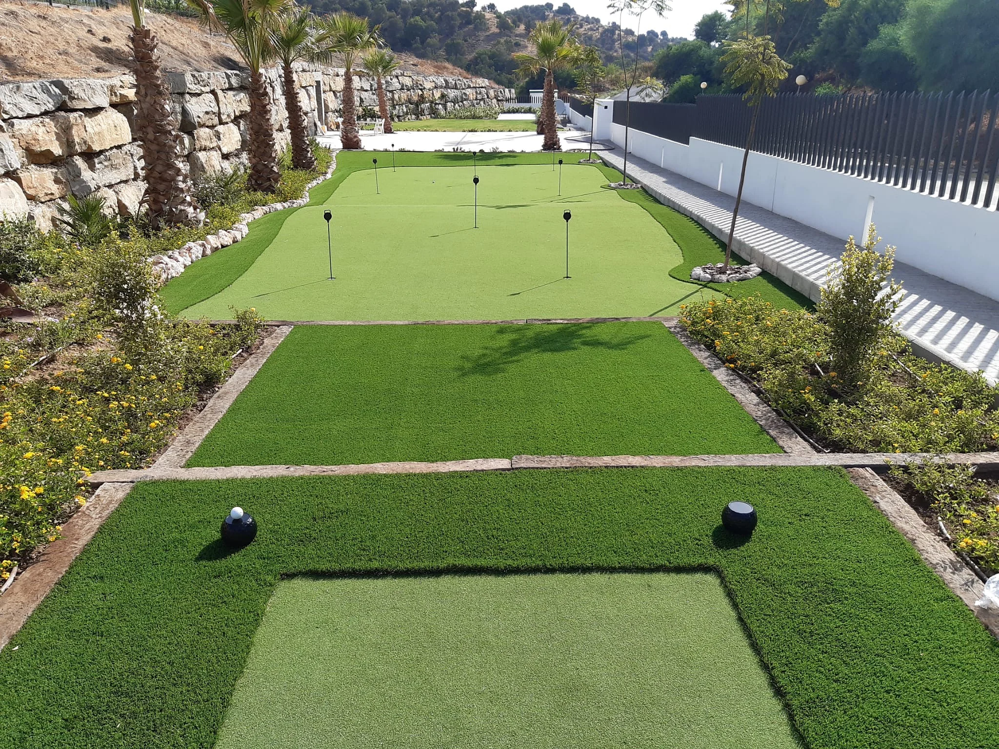 Multi-level custom putting green with tee zones, fringe and flags on the Costa del Sol